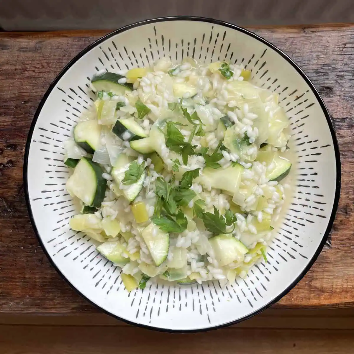 Autumn vegetable risotto In a white bowl on a wooden table