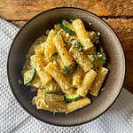 top view of mushroom courgette and ricotta pasta in a brown bowl