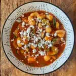 Rustic courgette and goats cheese gnocchi on a white ceramic plate