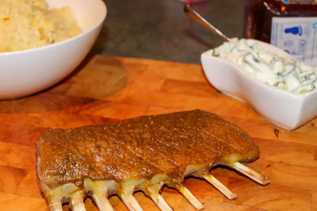 Fluffy pilau rice with cardamom and cloves served with spiced lamb chops