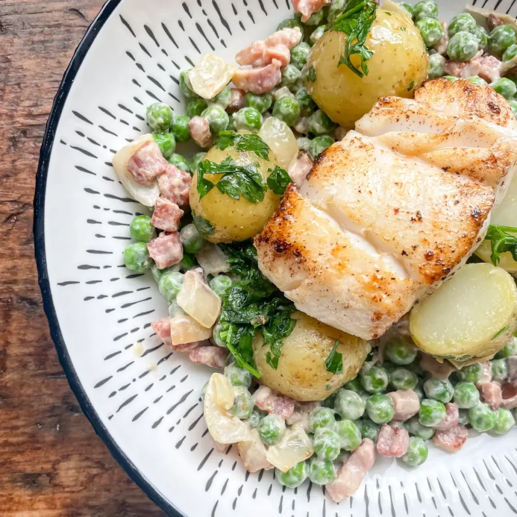 Bowl with creamy pancetta peas, potatoes and cod