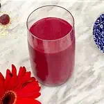 Bright red Black Forest fruits and beetroot smoothie in a glass