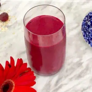 Bright red Black Forest fruits and beetroot smoothie in a glass