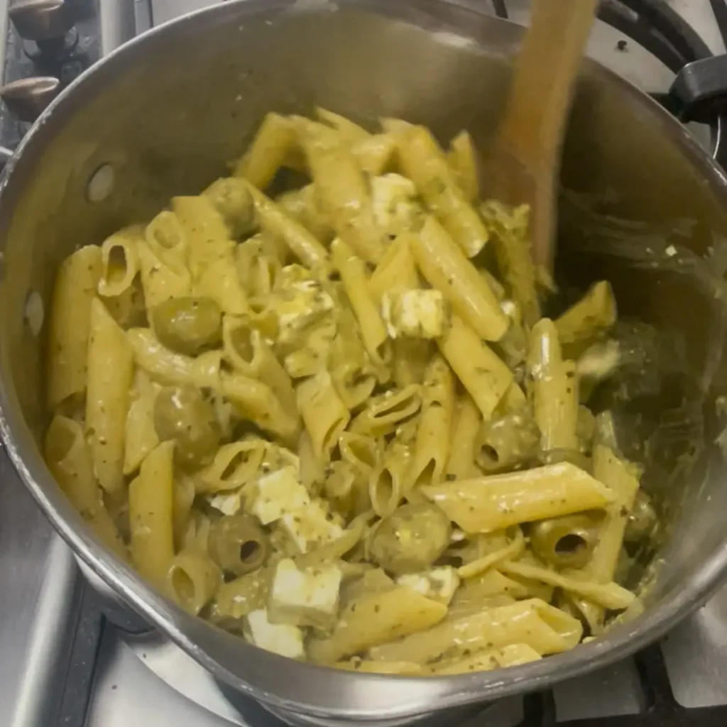 Process shot 4 - pesto pasta being stirred in a pan