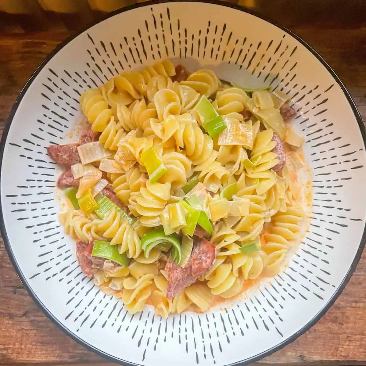 Cheesy chorizo pasta with golden leek garnish