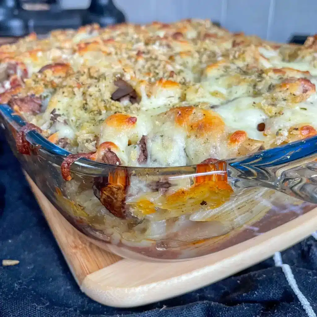 Close up of a cheesy corner of bolognese pasta bake