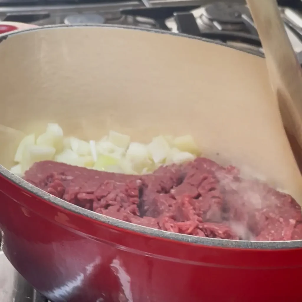 Bolognese pasta bake process shot 1 - cooking the onion garlic and beef mince