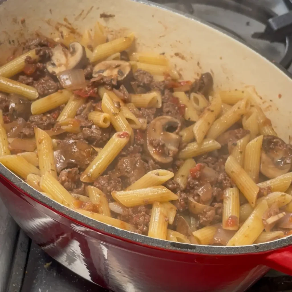 Bolognese pasta bake process shot 3 - adding the pasta and mixing