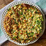 overhead view of a golden spring vegetable frittata with feta