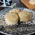 Three cheese scones on a black and white plate