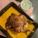 One pan curried roast chicken with golden pilau rice and raita on the side