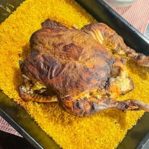 Yellow pilau rice made in one pan with a whole roast chicken