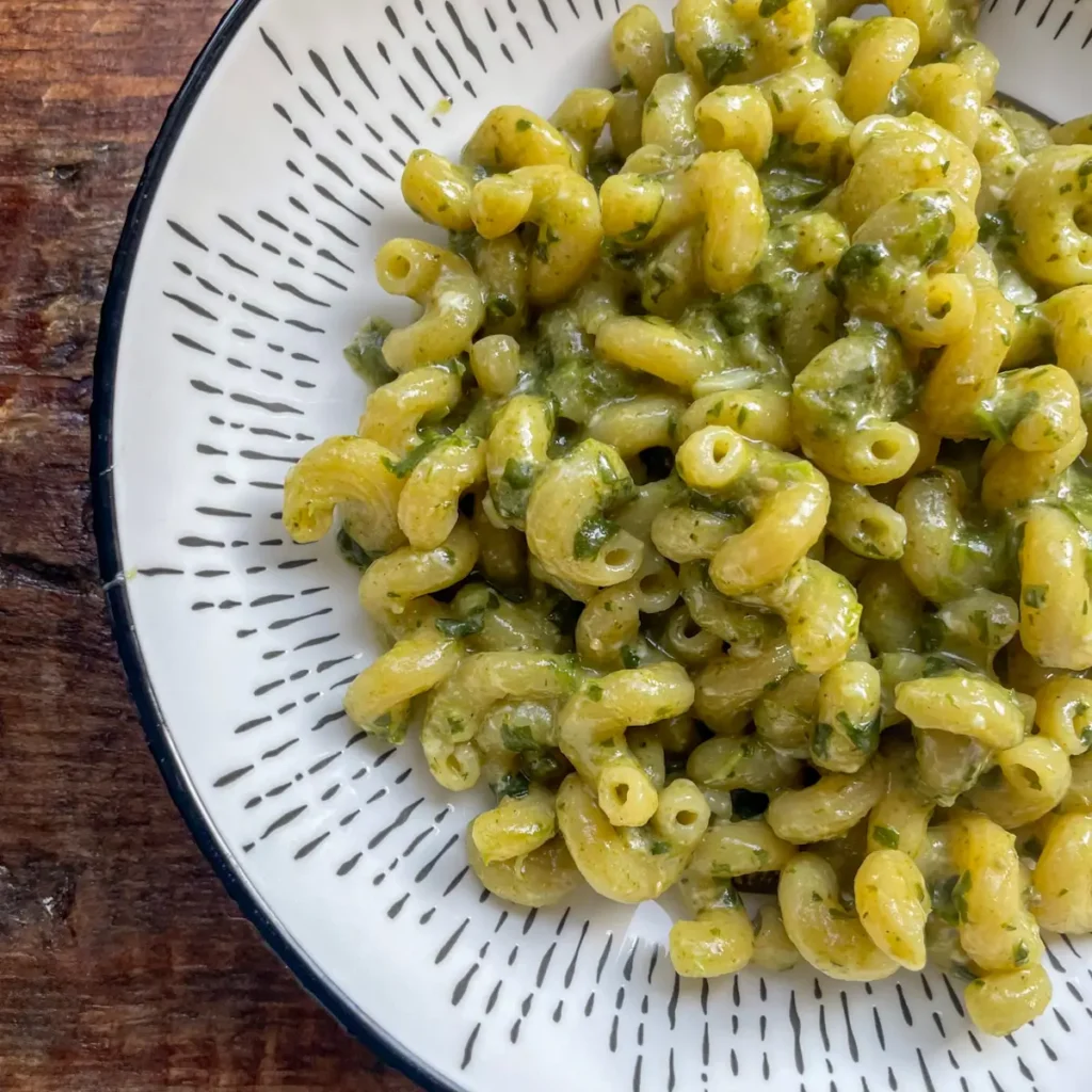 One pot spinach and pesto pasta in a white pasta bowl