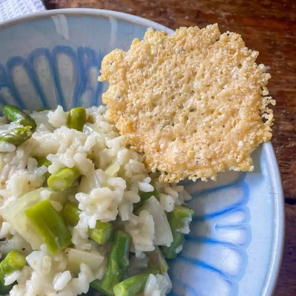Creamy asparagus risotto topped with parmesan crisps