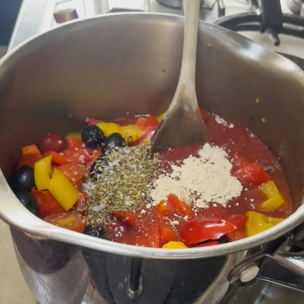 Process shot 2 - adding the passata, mixed herbs and garlic powder