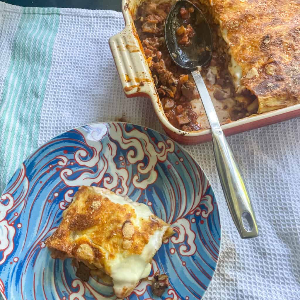 Classic beef lasagne With a serving on a blue plate