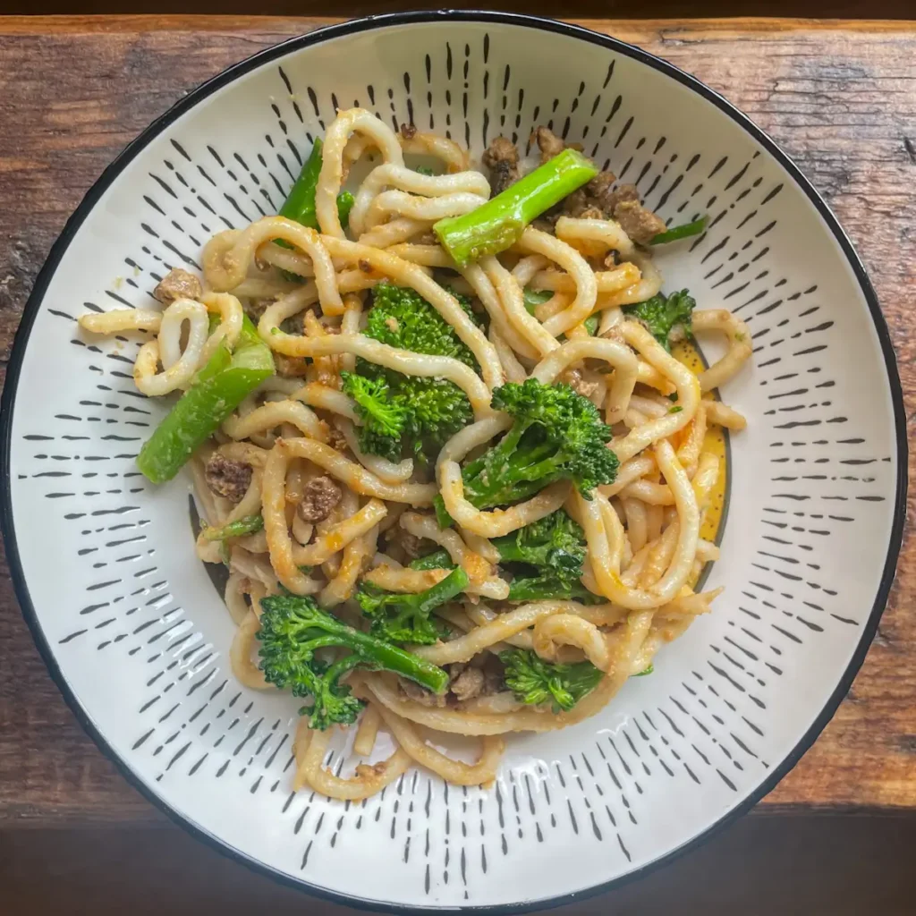 vegetarian satay noodles in a white bowl
