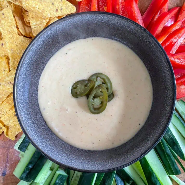 Nacho cheese sauce Surrounded by cucumber peppers and nachos