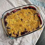 Apple and blackberry crumble On a white tea towel