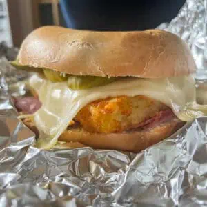 Pastrami and cheese bagels With hash browns and pickles