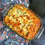 Creamy pesto pasta bake Top view with golden cheesy topping