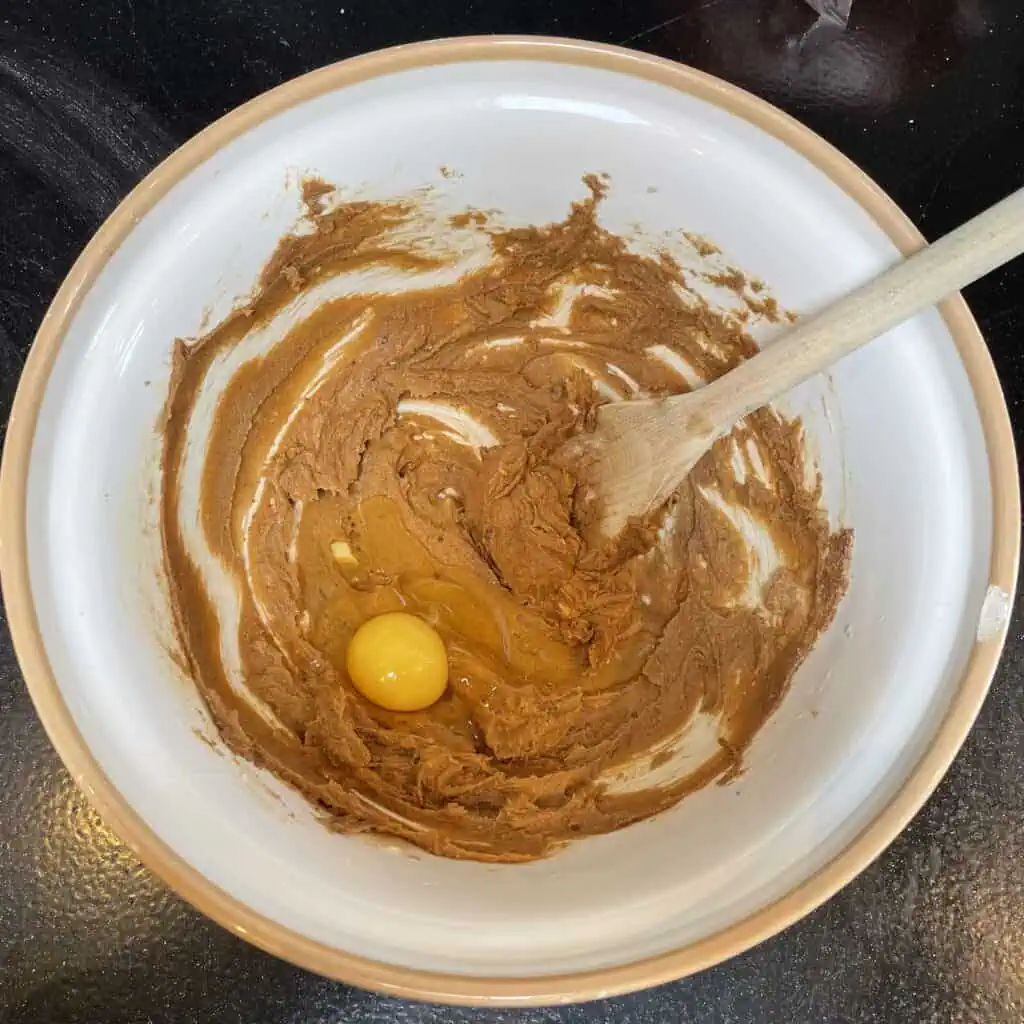 Step three for making apple loaf cake: add the eggs one at a time, mixing thoroughly between each one