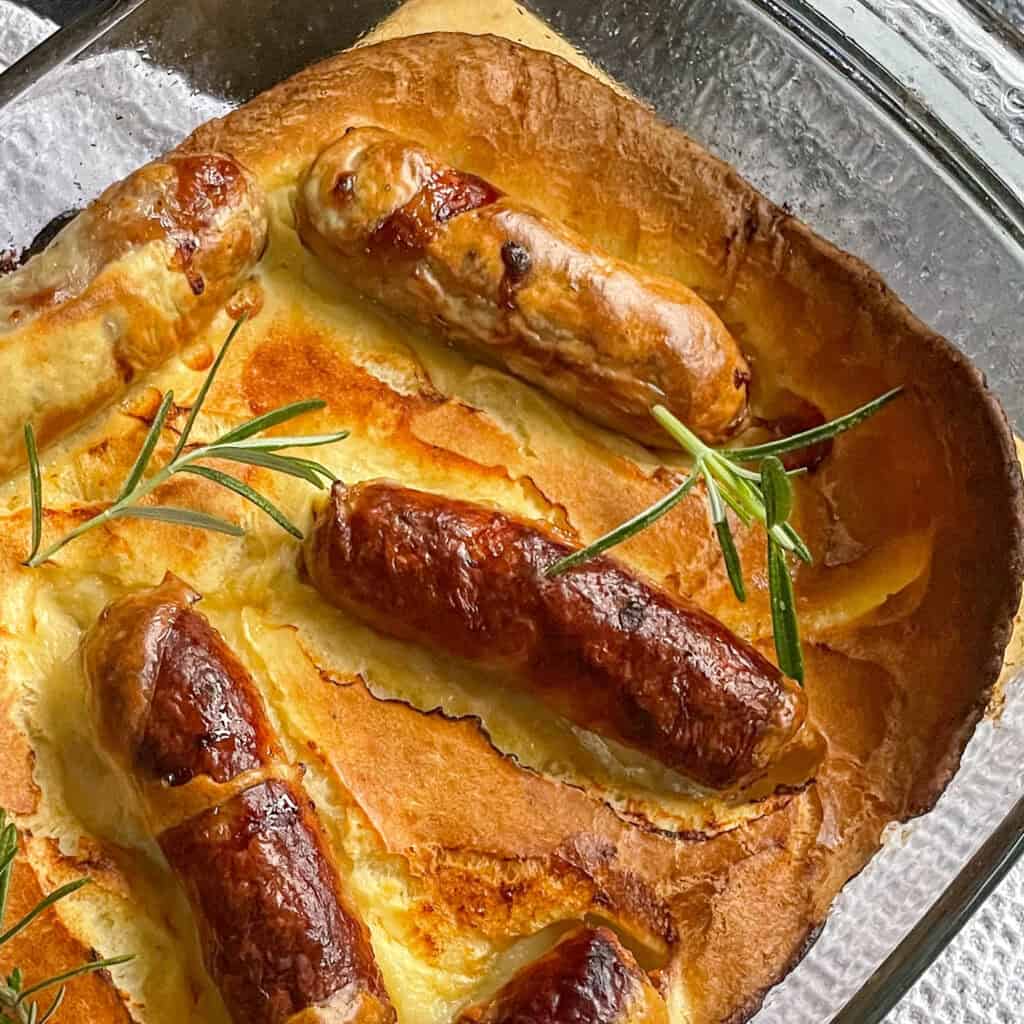 Toad-in-the-hole with onion gravy Topped with sprigs of rosemary