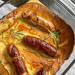 Toad-in-the-hole with onion gravy Topped with sprigs of rosemary
