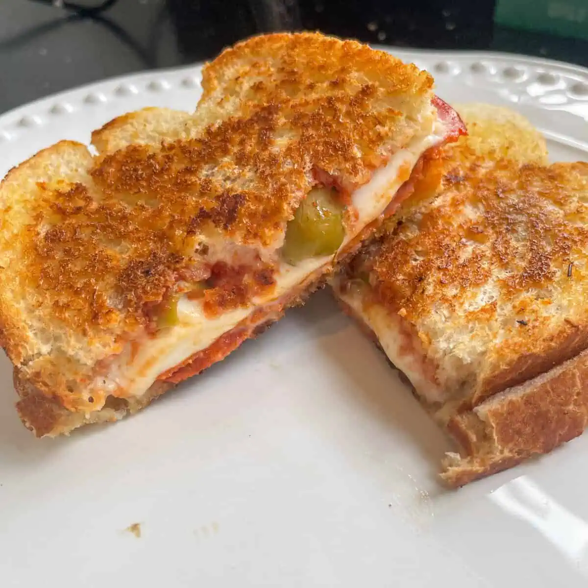 Chorizo and mozzarella hot sandwich Close up with green olives