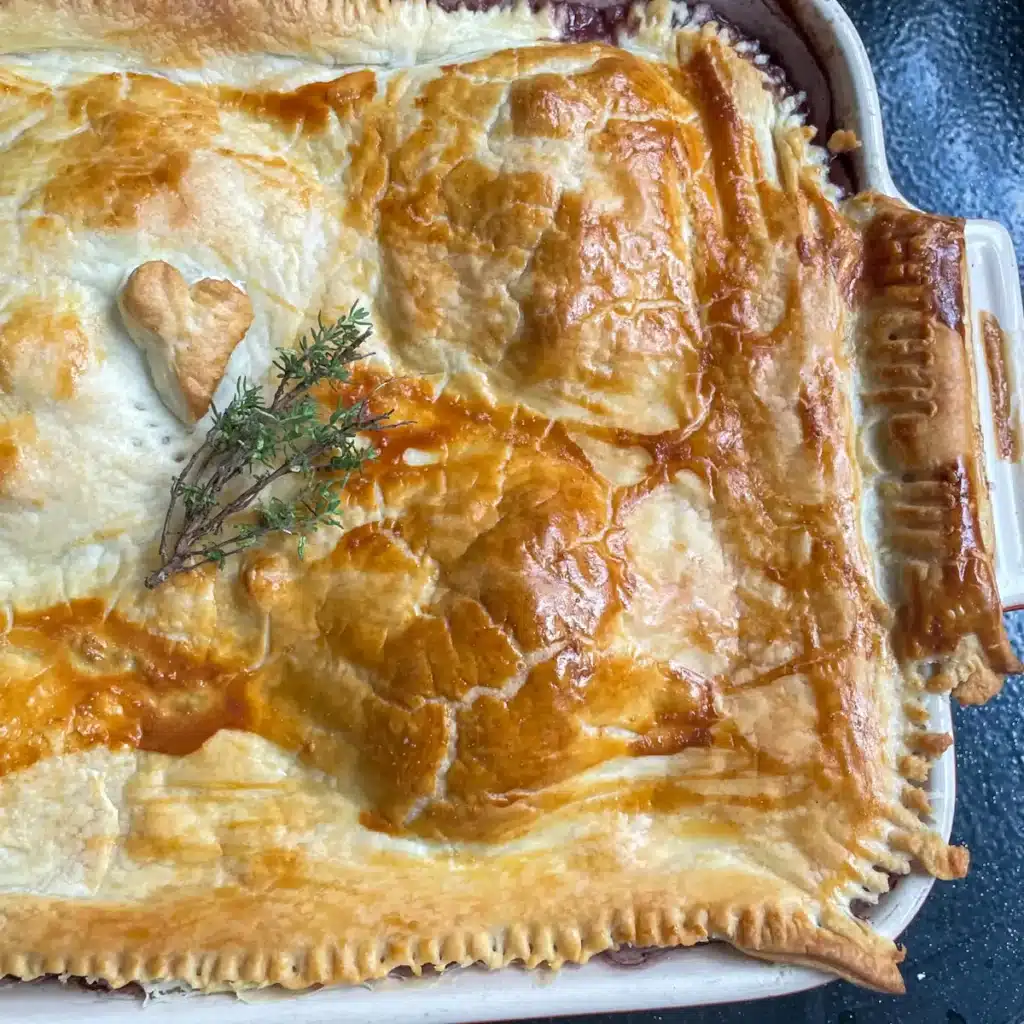 Coq au vin pie with a golden pastry lid