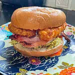 Avocado and bacon bagel With crispy golden hashbrowns for breakfast or brunch