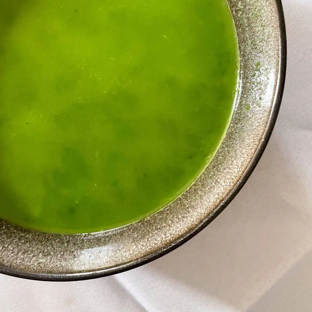 Bright green watercress soup served in bowl