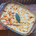 The best cauliflower cheese In a glass dish on a wooden table
