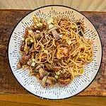 Vegan mushroom and ginger stir fry In a white bowl on a wooden table