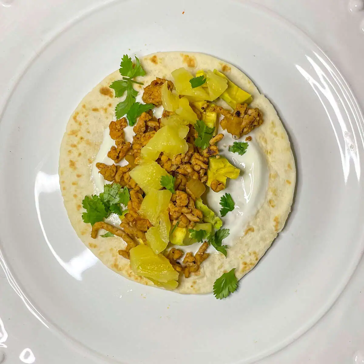 Quick pork tacos recipe with avocado and soured cream topping