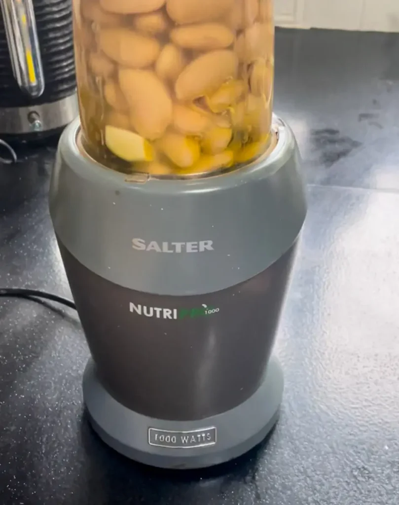 Blending white bean hummus ingredients in a smoothie maker