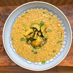 Coconut and lentil dal with red lentils topped with fried courgettes