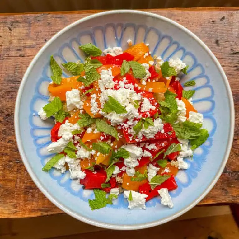quinoa feta and roasted red pepper salad in a blue bowl