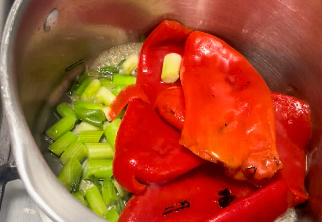 Starting the soup base with spring onions and red peppers
