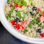 Vegan quinoa salad with tomatoes, cucumber, olives, lemon juice, and mint – fresh and easy homemade side dish or light main.