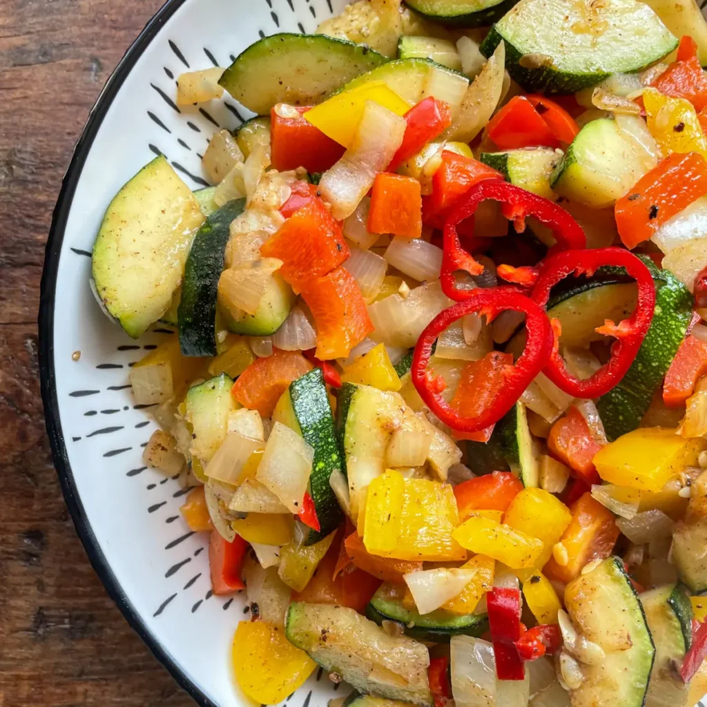 close up of salt and pepper courgettes topped with sliced red chilli