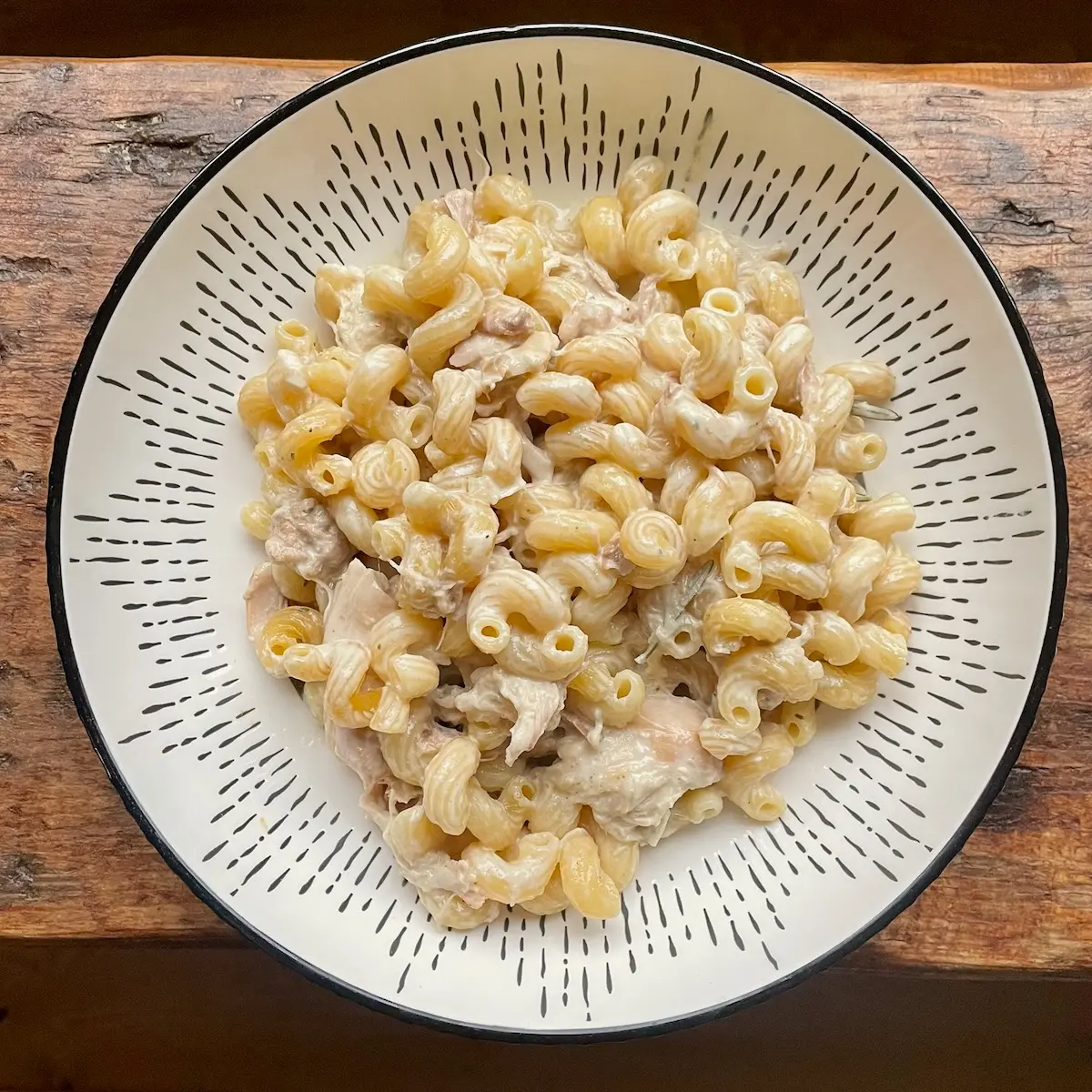 creamy one pot chicken pasta served in a white bowl