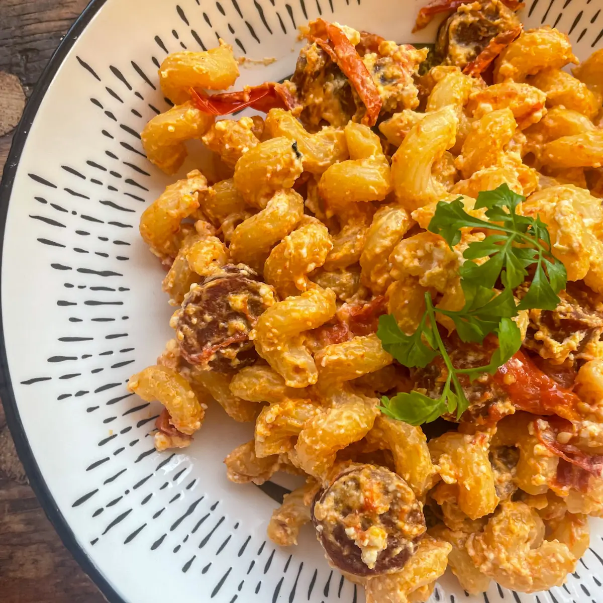 baked feta pasta with chorizo and tomatoes in a bowl