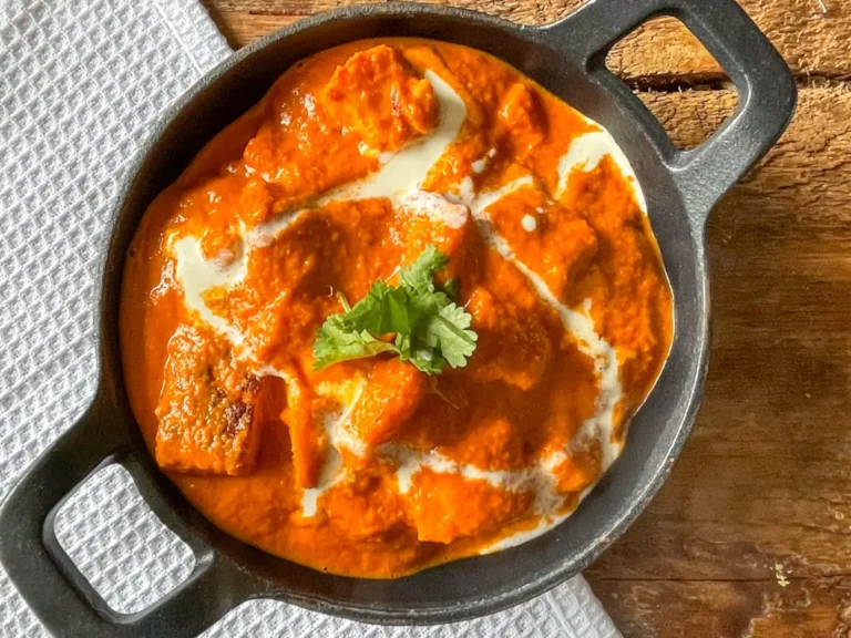 butter halloumi curry in a black cast iron dish