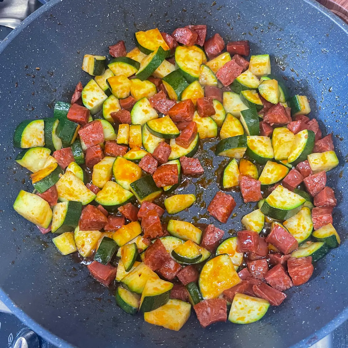 chorizo and courgette cooking in a pan