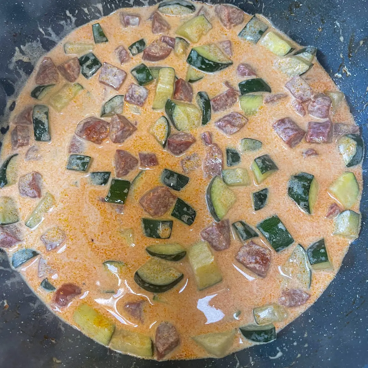 adding cream to the pan and simmering