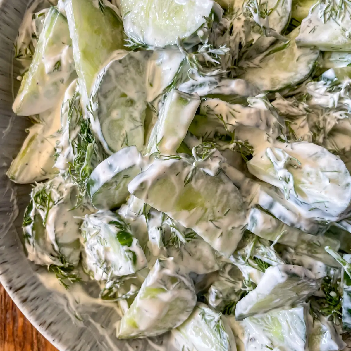 close up of creamy cucumber salad with dill