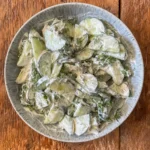 overhead view of cucumber salad in a blue bowl
