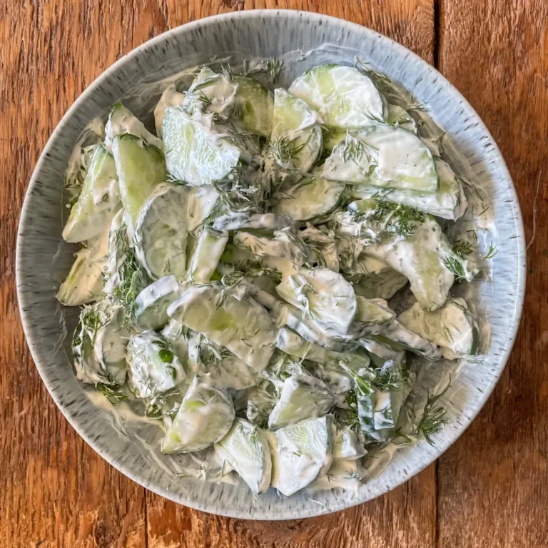 overhead view of cucumber salad in a blue bowl