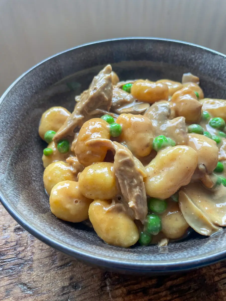 leftover roast duck gnocchi in a black bowl